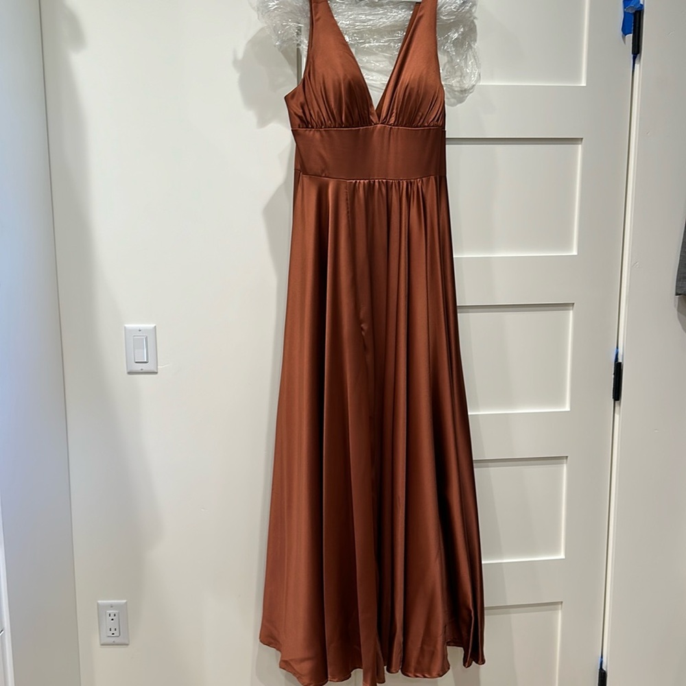 Copper colored satin gown with front slit and flowing fabric. Fall perfection!
